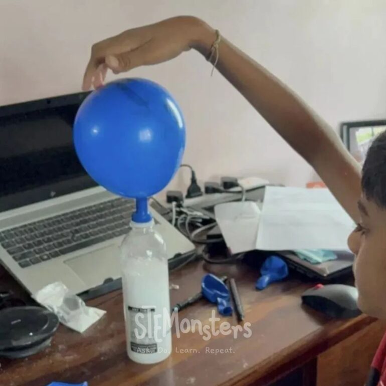 Student inflating a balloon with a baking soda and vinegar reaction during a live online class